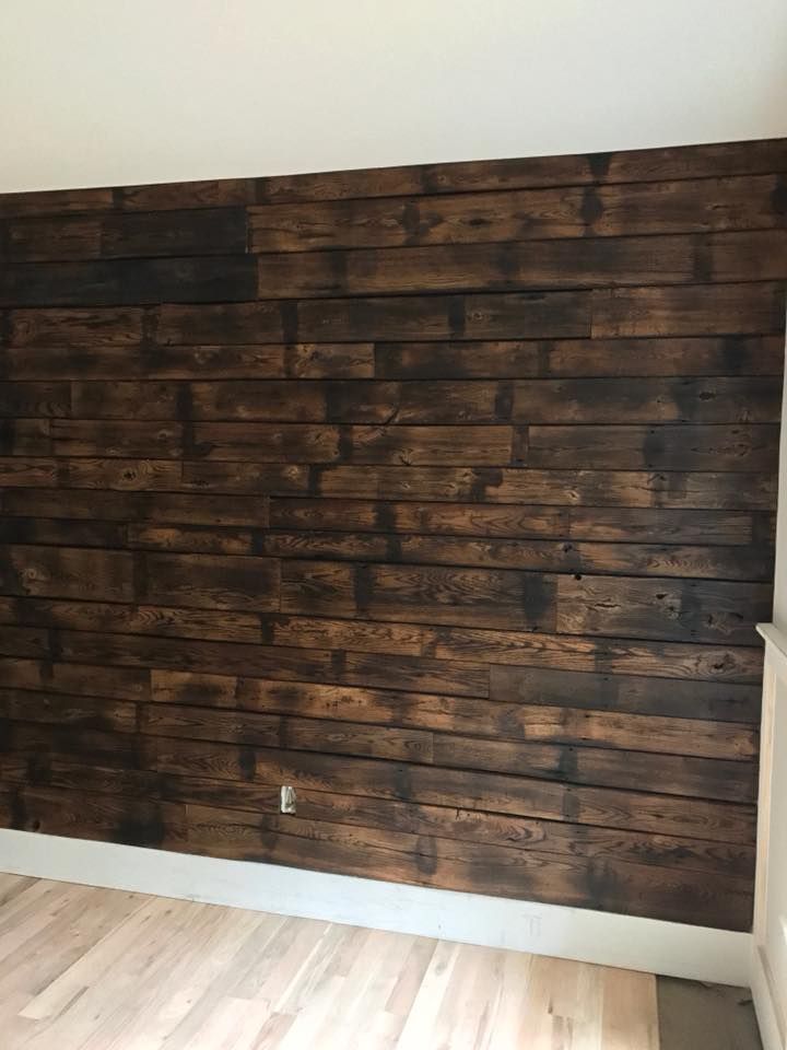 an empty room with wood paneling on the wall