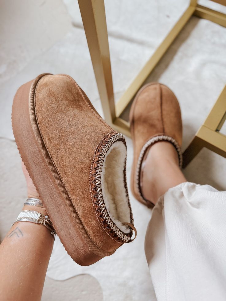 Step up your cozy game with our Cabin Cozy Tan Platform Slip-Ons! These stylish slippers feature a soft, plush interior lining for ultimate comfort, a thick supportive foam insole, and a sturdy, non-slip sole for added safety. The reinforced stitching detail and convenient slip-on style make these perfect for any occasion. Plus, the breathable inner lining and black & white upper stitching detail add a touch of style to these comfortable and functional slippers. So why settle for boring, when yo Comfortable Platform Slippers With Cushioned Footbed And Round Toe, Winter Slippers With Plush Lining And Round Toe, Comfortable Platform Slippers With Cushioned Footbed, Comfortable Slip-on Platform Slippers With Cushioned Footbed, Fall Cushioned Synthetic Slippers, Comfy Slip-on Synthetic Slippers, Fall Synthetic Slippers With Cushioned Footbed, Super Soft Winter Slippers With Round Toe, Fall Season Synthetic Slippers With Cushioned Footbed