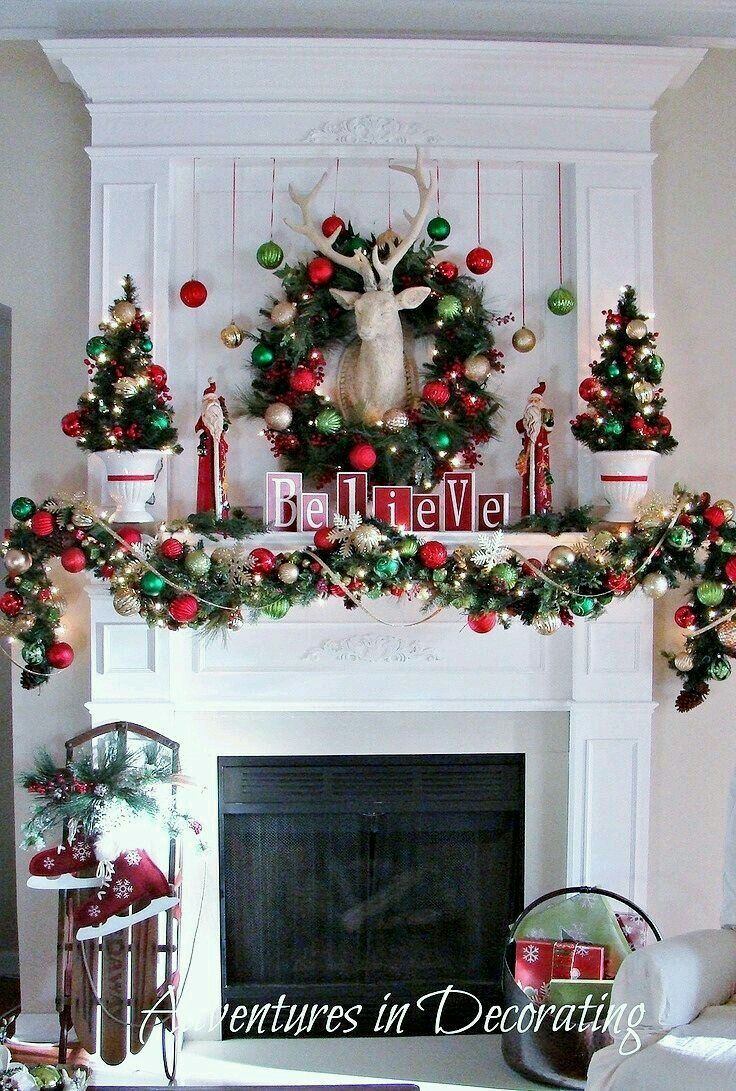 a mantel decorated with christmas decorations and deer heads