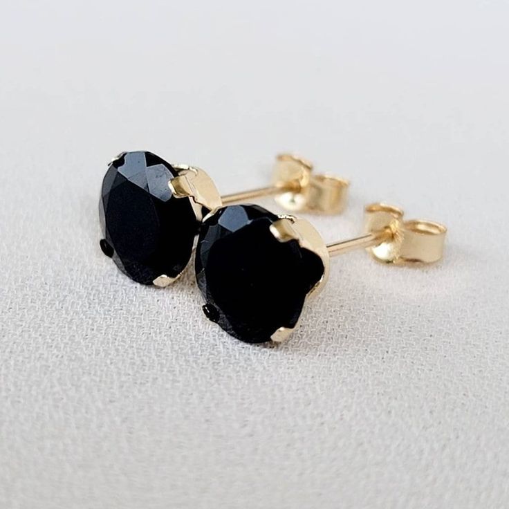 Embrace timeless sophistication with our genuine black onyx stud earrings. The deep, velvety black of onyx exudes a sense of mystery and elegance. Meticulously crafted for understated beauty, these studs add a touch of classic refinement to any ensemble. Elevate your style with the enduring charm of black onyx, a versatile and stylish addition to your jewelry collection. Two round genuine 6mm black onyx studs. These classic earrings are available in your choice of a 14K gold-filled setting, 14k Elegant Black Everyday Earrings, Minimalist Black Pierced Jewelry, Classic Black Jewelry For Everyday, Minimalist Tarnish Resistant Black Earrings, Minimalist Black Tarnish Resistant Earrings, Elegant Black Tarnish-resistant Earrings, Black Earrings With Prong Setting In Fine Jewelry, Black Prong Setting Earrings Fine Jewelry, Black Prong Set Fine Earrings