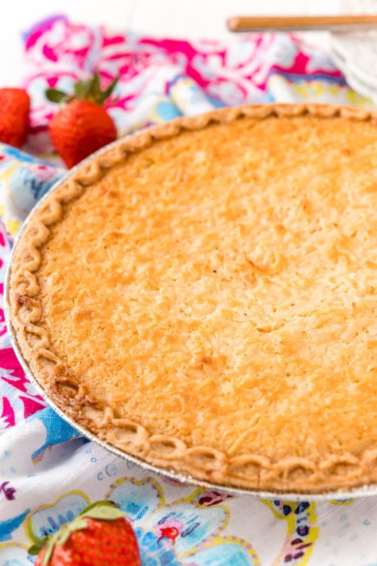 a pie sitting on top of a table next to strawberries