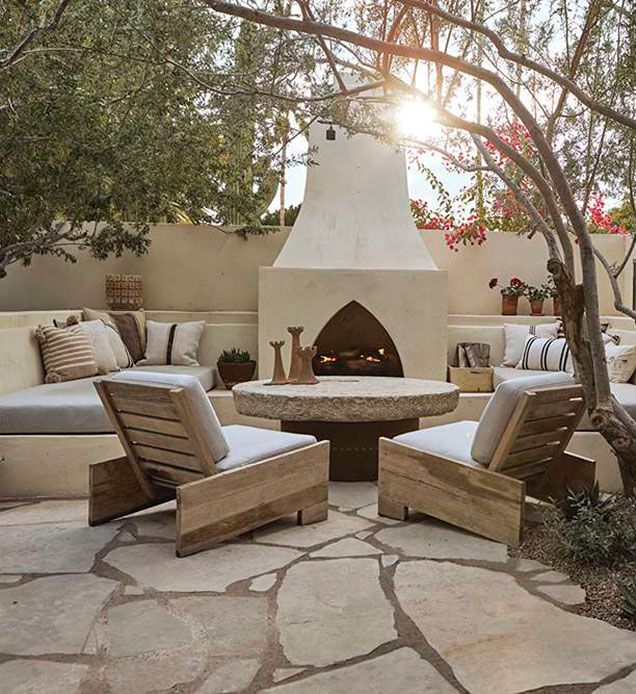 an outdoor patio with chairs and a fire place