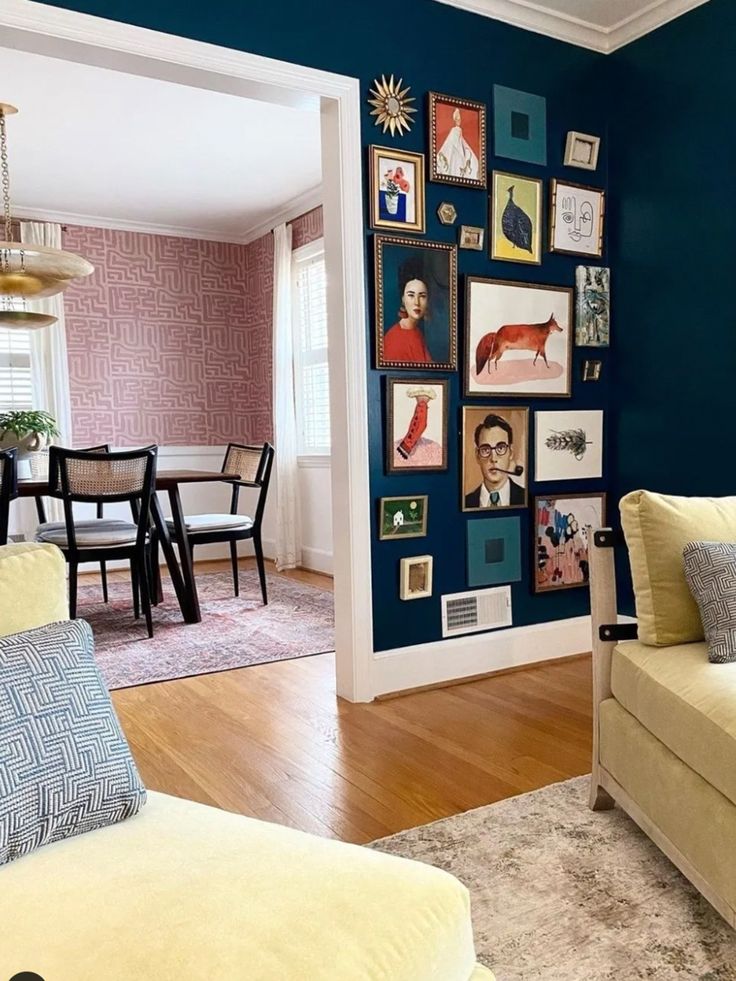 a living room filled with furniture and pictures on the wall