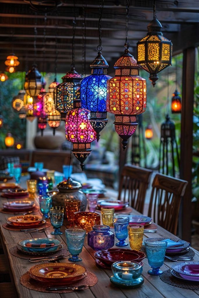 a long table with many colorful lights hanging from it's ceiling and plates on the table