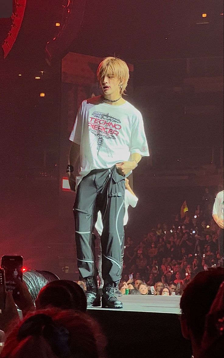 a man standing on top of a stage in front of a crowd