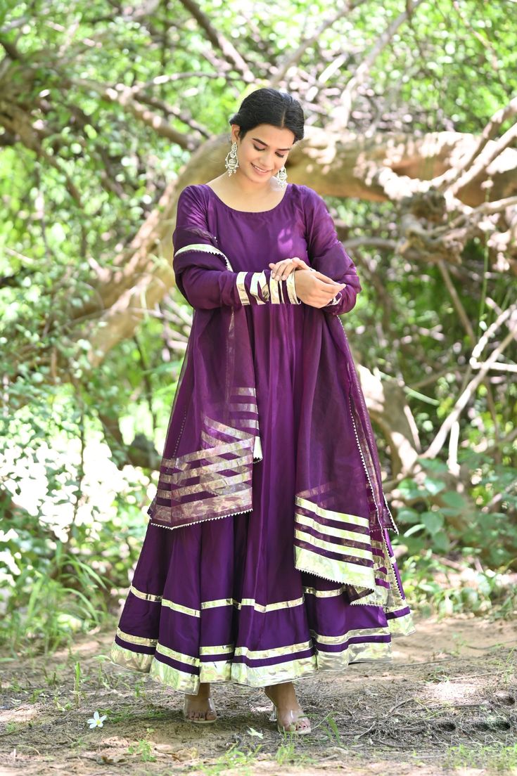 PRODUCT DESCRIPATION This festive season , be ready to impress! Shop it now and make Diwali memorable!Anarkali :- Upada silkPant :- CottonDupatta :- Organza silkClosure Used:- Side zipColor:- Deep purpleCare Instructions :- Dry clean onlyModel Size :- Model is wearing XS sizeModel Height :- 5.5'DISCLAIMER :- Slight color variations may occur due to different screen resolution. Navratri Silk Anarkali Set With Dabka Details, Semi-stitched Raw Silk Anarkali Set For Diwali, Silk Anarkali Set With Dabka For Navratri, Dabka Silk Anarkali Set For Navratri, Anarkali Art Silk Salwar Kameez With Dabka, Festival Slub Silk Anarkali Set With Dabka, Festival Slub Silk Anarkali Set With Dabka Detail, Purple Silk Kurta With Gota Work, Anarkali Slub Silk Dupatta With Cutdana Details