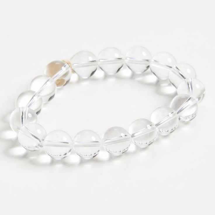 Our elegant glass bracelet adds a touch of class to any outfit. The perfect accessory for any occasion. Feel fabulous wearing this timeless piece. Transparent glass beads Elastic band Sterling with Gold Plate Transparent Beads Bracelet, Elegant Adjustable Crystal Stretch Bracelet, Elegant Adjustable Stretch Bracelet With Round Beads, Elegant Crystal Bracelet With Clear Round Beads, Clear Glass Jewelry With Faceted Beads, Formal Clear Round Beaded Jewelry, Beaded Glass Round Bracelet, Elegant Beaded Glass Stretch Bracelet, Elegant Clear Round Beaded Bracelets