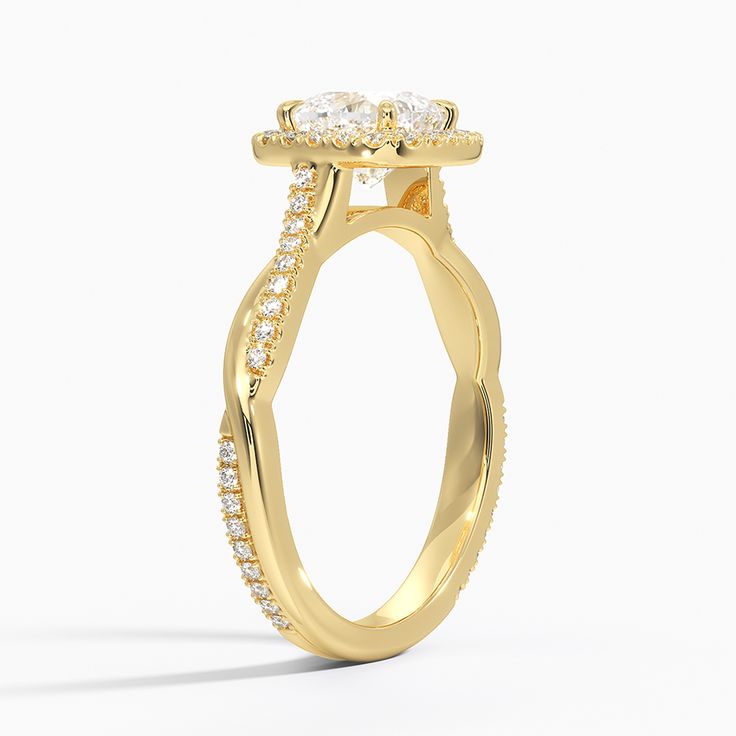 a yellow gold engagement ring with diamonds on it