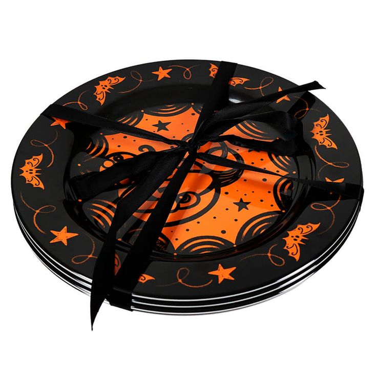 an orange and black plate with star designs on the rim, tied in a black ribbon