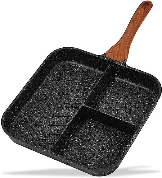 an iron skillet with wooden handle and two compartments on the side, in front of a white background