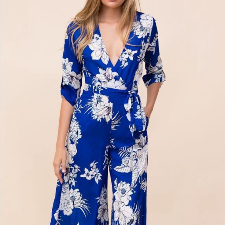 New Without Tags. Zipper In The Back Gorgeous One Piece. Chic Blue Jumpsuits And Rompers For Spring, Blue Printed Jumpsuit For Spring, Blue Printed V-neck Jumpsuits And Rompers, Blue Floral Print Jumpsuits And Rompers For Day Out, Blue Jumpsuits And Rompers For Spring, Blue Long Sleeve Jumpsuits And Rompers For Vacation, Blue Long Sleeve Jumpsuit For Vacation, Blue Fitted Jumpsuits And Rompers For Brunch, Blue Floral Print Jumpsuits And Rompers For Party