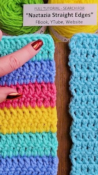 there is a crochet square with a finger on it and two balls of yarn in the background