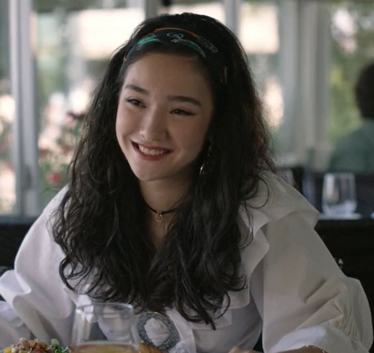 a woman sitting at a table with food in front of her