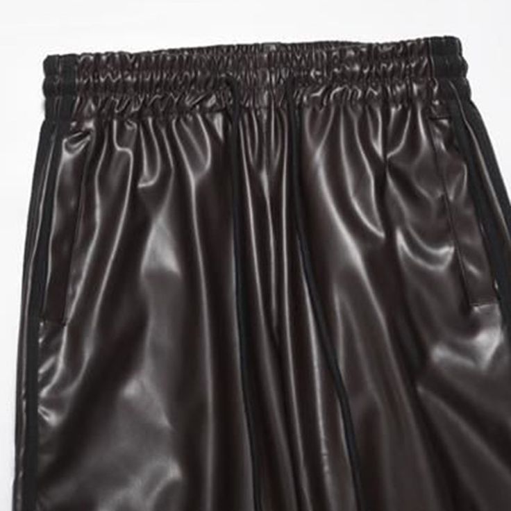 Men's Trendy Wide-Leg Leather Bottoms - Elevate your fashion game with these sleek and stylish leather bottoms featuring a wide-leg design. Perfect for adding a touch of modern sophistication to your look. 💼👖 Features: 🕶️ Bold Fashion Choice: Elevate your style with our unique and trendy wide-leg leather bottoms. 💥👖 🌟 Distinct Polyester Fabric: Crafted with a high-quality dobby weave for a textured and captivating look. 🧵🎨 🎒 Adjustable Drawstring Closure: Enjoy a comfortable fit with a Sleek Black Wide-leg Leather Pants, Black Leather Wide-leg Pants, Wide-leg Black Faux Leather Pants, Black Faux Leather Wide-leg Pants, Streetwear Wide Leg Faux Leather Pants, Trendy Black Wide-leg Leather Pants, Wide Leg Faux Leather Pants For Streetwear, Faux Leather Wide Leg Pants For Streetwear, Wide Leg Faux Leather Bottoms For Streetwear