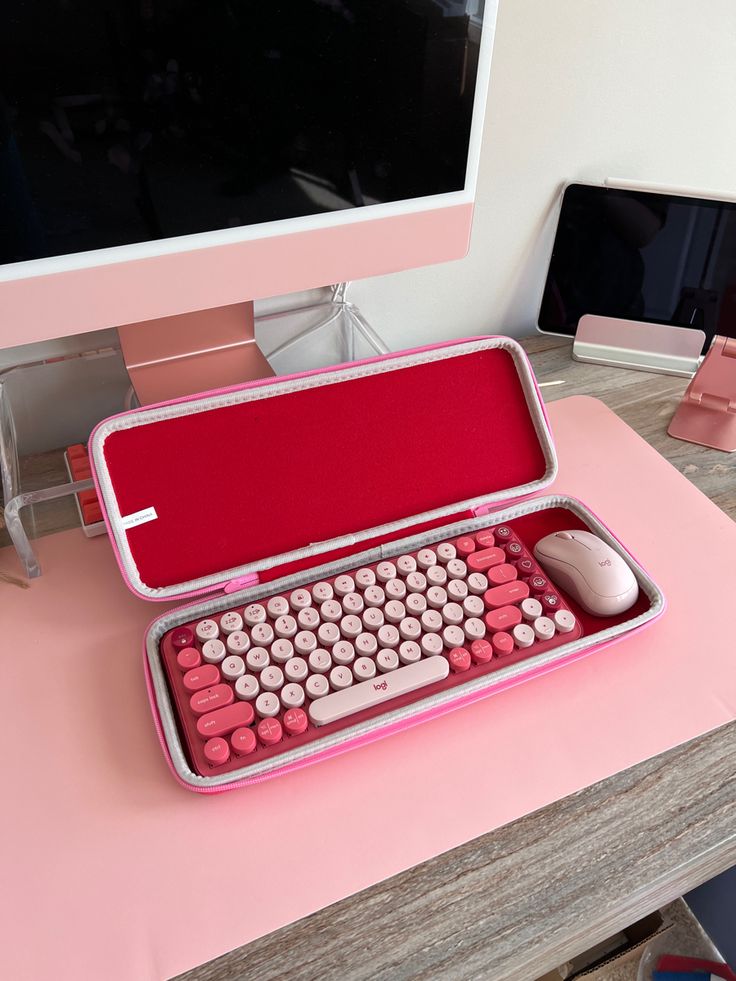 a pink computer case sitting on top of a desk next to a keyboard and mouse