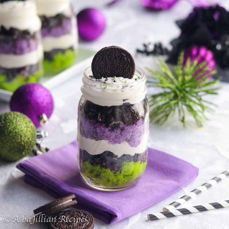 an oreo cookie in a jar on top of a purple napkin next to other cookies