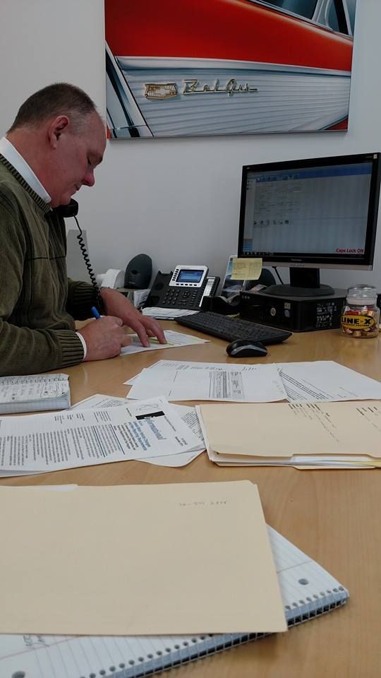 a man sitting at a desk with papers on it