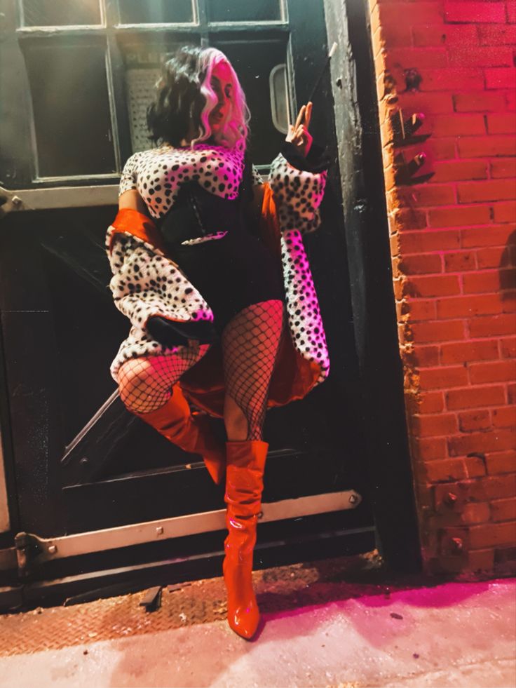 a woman is standing in front of a door and posing for the camera with her legs crossed