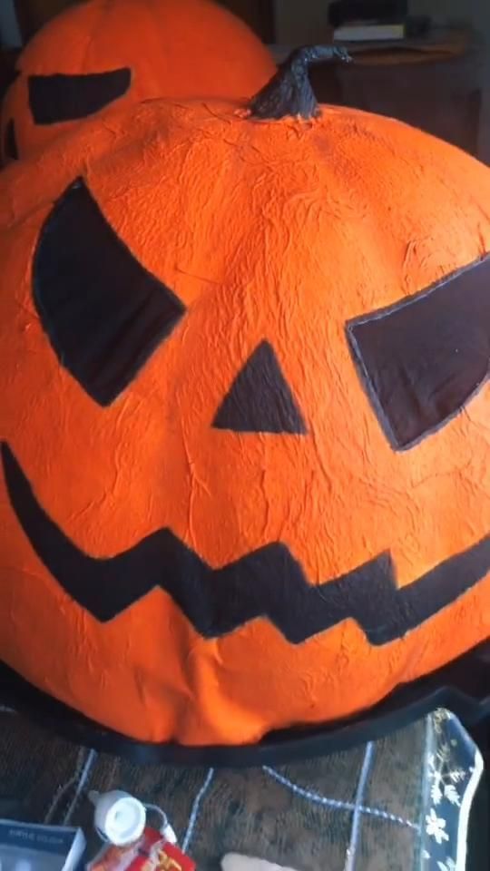 an orange pumpkin sitting on top of a table