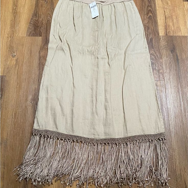 This Is Such A Fun Skirt. It’s A Pull On With Fringe At The Bottom. Have Fun With Your Outfit By Adding This Skirt. Beige Pleated Skirt For Beach, Spring Fringe Skirt, Long Vacation Skirt, Spring Fringe Skirt Bottoms, Long Fringe Skirt For Summer, Cheap Casual Fringe Skirt, Fringe Midi Skirt For Summer, Casual Fringe Skirt For Spring, Beach Midi Skirt In Beige