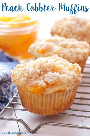 three peach cobbler muffins on a cooling rack