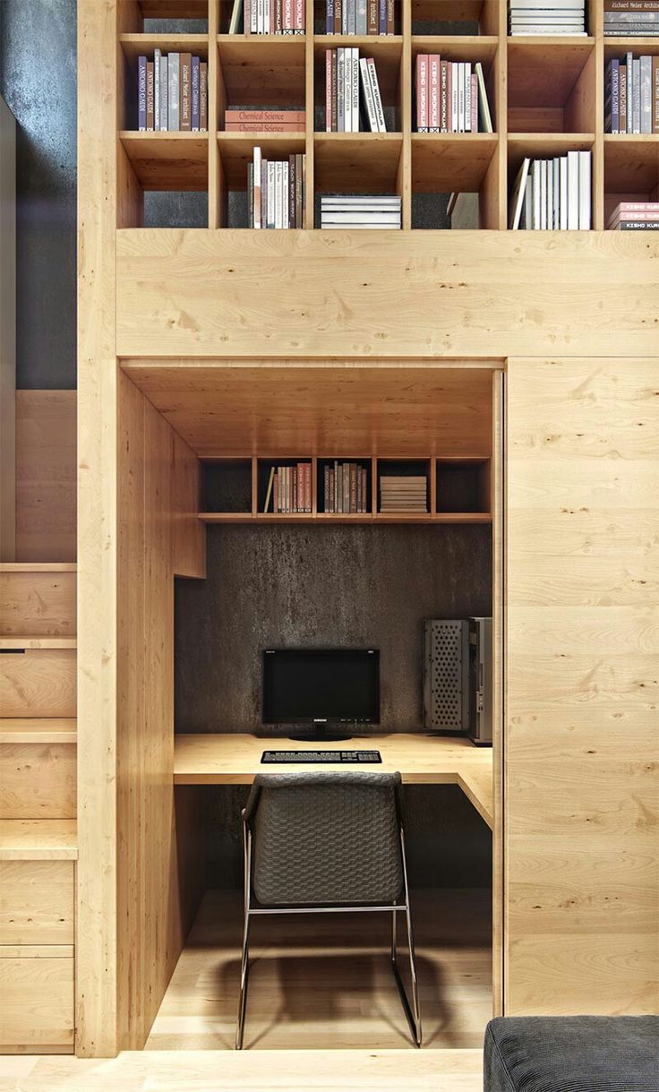 a home office with built in bookshelves and desk