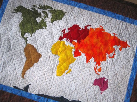 the world map is made out of crochet yarn and has different colors on it