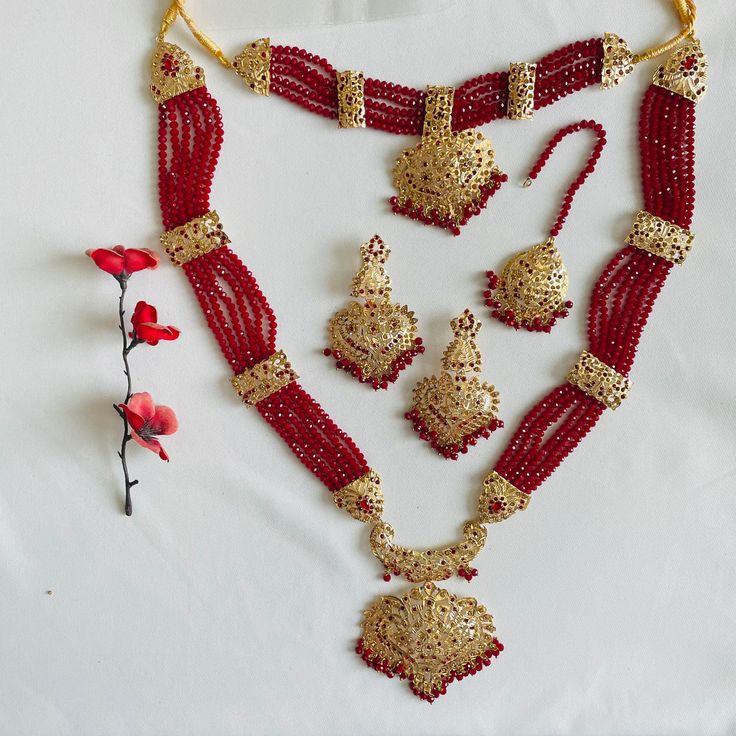 M U G H A L  Style Gold-Plated Complete Bridal Set  This set is adorned with maroonish red diamond cut pearls, real shiny stones and high quality base metal. Quality of this set is a guarantee!  6 piece set includes: * Guluband * Rani Haar  * Tikka * Jhumar  * Earrings * Nath Jewellery comes in a complementary large size luxury red velvet box- perfect to keep it safe!  Please check our Instagram page @nuzeedofficial for more bridal jewellery and outfits at affordable prices. Red Hand Set Jewelry For Festivals, Festive Red Ruby Jewelry Set, Red Jewelry Sets For Diwali, Red Ruby Jewelry Sets For Diwali, Ruby Jewelry Sets With Stone Work For Celebration, Heavy Red Jewelry Sets For Diwali, Red Elaborate Jewelry Sets For Festivals, Festive Red Stone Work Jewelry Sets, Celebration Ruby Jewelry Sets With Stone Work