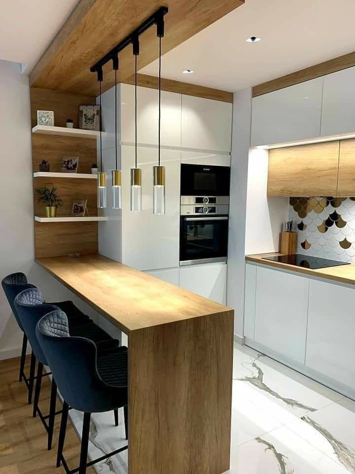 a modern kitchen with white cabinets and wooden counter tops, along with bar stools