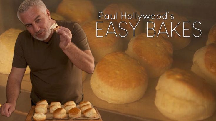 an old man is eating some bread in front of many rolls on a table with the words paul hollywood's easy bakes