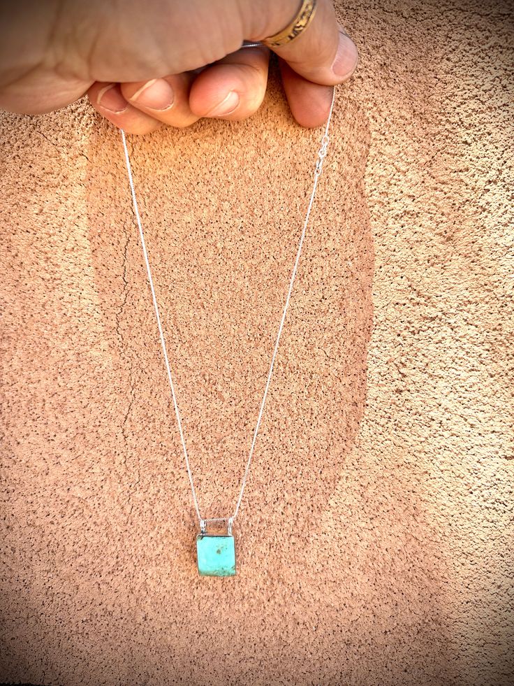 This is a simple but cute little pendant. It is perfect as an everyday accessory. Made of .925 sterling silver with a beautiful turquoise stone and set on an 18" chain. Turquoise Rectangular Pendant Necklace In Sterling Silver, Turquoise Sterling Silver Rectangular Pendant Necklace, Turquoise Sterling Silver Necklace With Rectangular Pendant, Sterling Silver Turquoise Necklaces Stamped 925, Turquoise Sterling Silver Necklaces Stamped 925, Turquoise Sterling Silver Necklace Stamped 925, Sterling Silver Turquoise Necklace With Large Pendant For Gift, Silver Sterling Turquoise Necklace With Rectangular Pendant, Dainty Sterling Silver Turquoise Necklace Gift