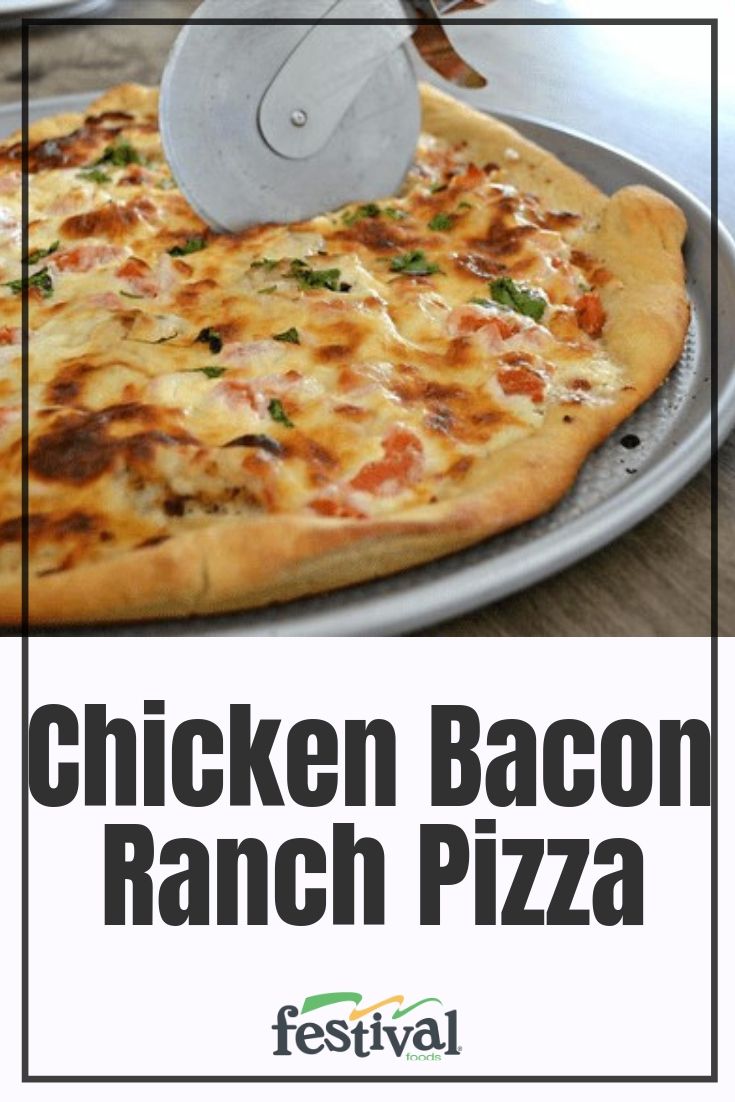 the chicken bacon ranch pizza is ready to be cut into slices with a spatula