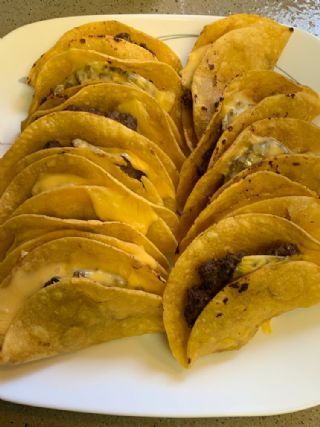 a white plate topped with tortillas covered in cheese