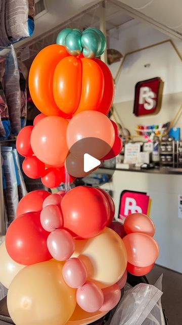 a bunch of balloons that are on top of a table in a room with other items