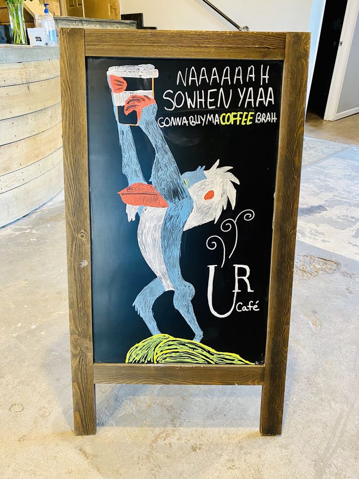 a chalkboard sign with an image of a monkey holding a beer in its hand