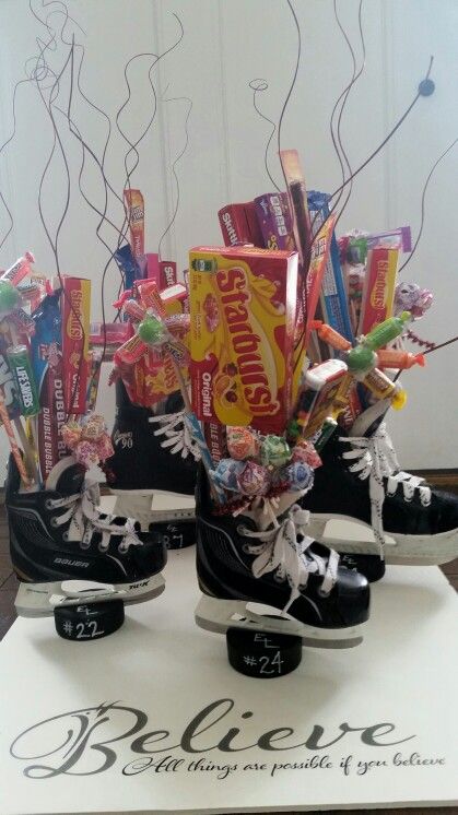 two ice skates with candy and candies in them sitting on top of a sign