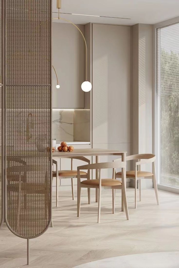 a dining table and chairs in a room next to a large window with sliding glass doors