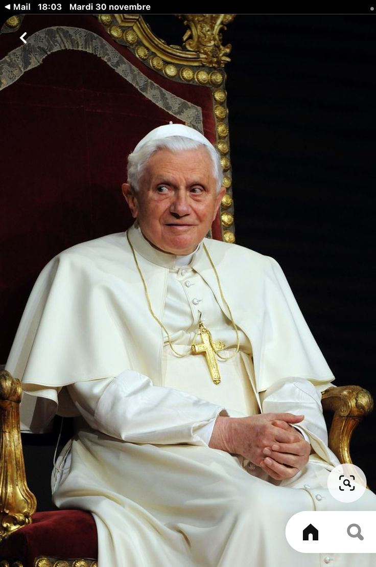 the pope is sitting down in his chair