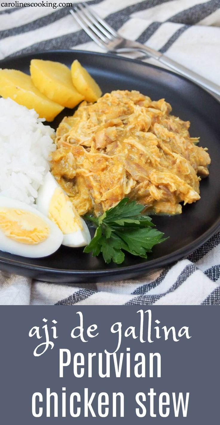 an image of chicken stew on a black plate with rice and sliced pineapples