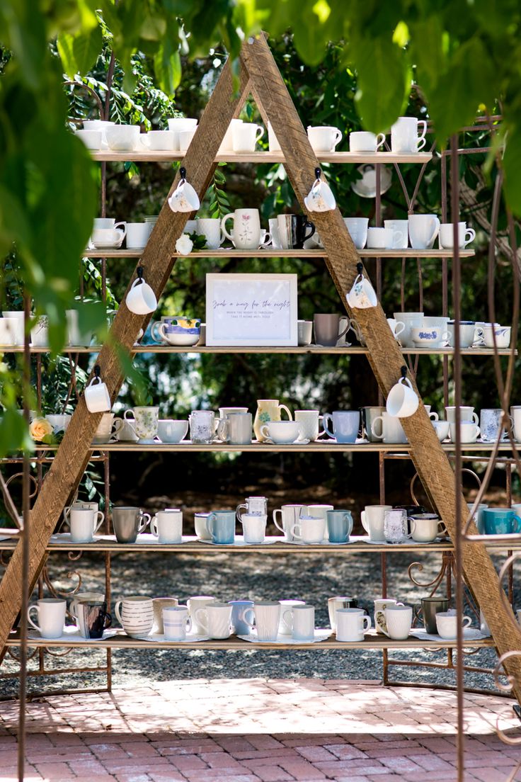 an outdoor display with tea cups and saucers