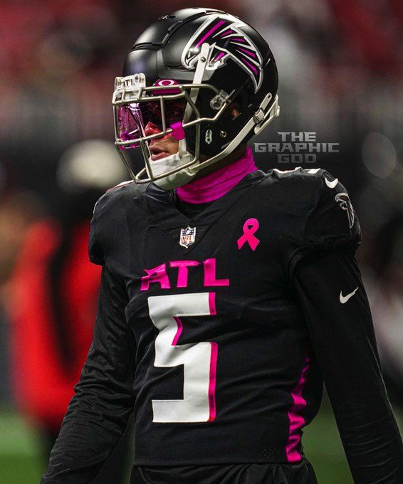 a football player wearing a black and pink uniform with the number 1 on it's chest