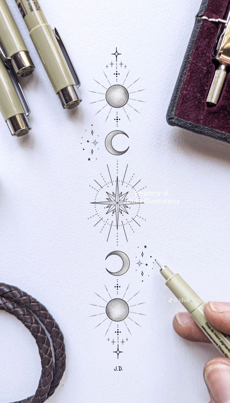 someone is drawing the moon and stars on paper with their pen, scissors, and other items