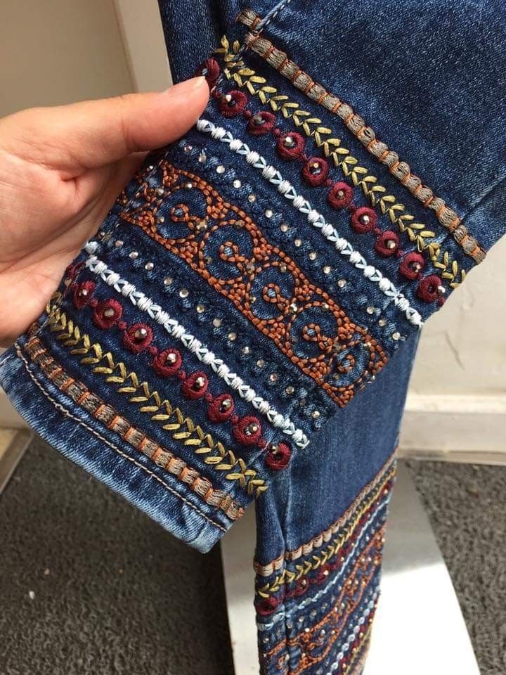 someone is holding their jeans with beading on them