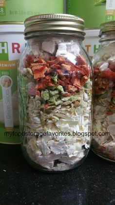 three jars filled with food sitting on top of a counter