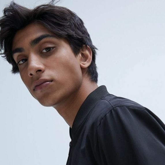 a close up of a person wearing a black shirt and looking off to the side