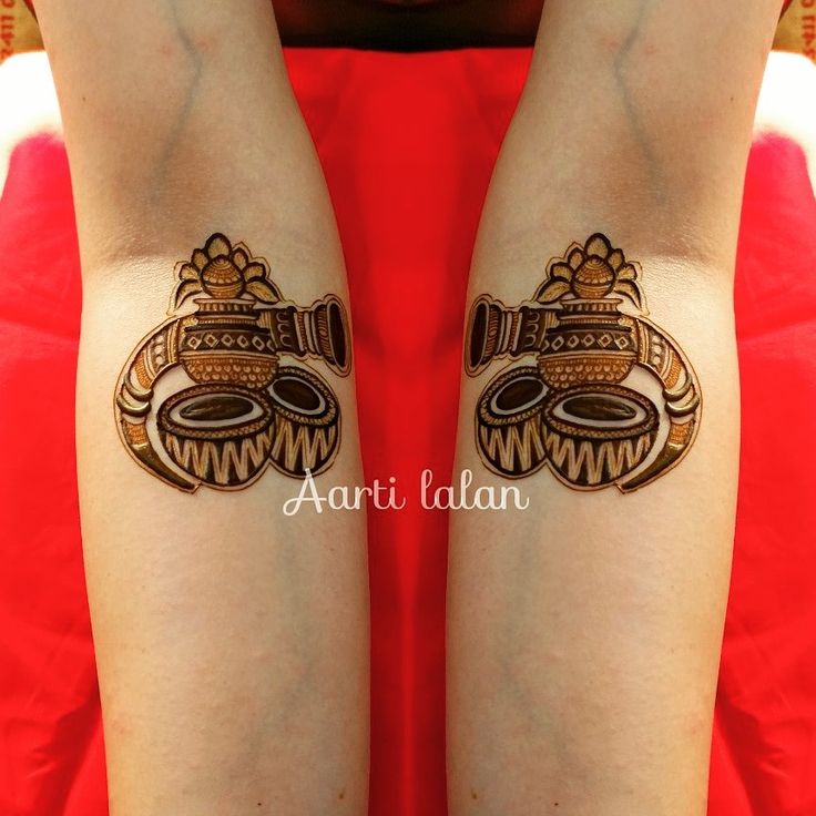 a woman's legs with hendi tattoos on them