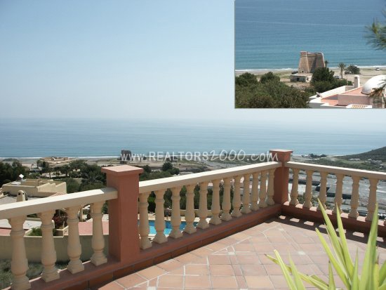 a balcony overlooking the ocean and beach