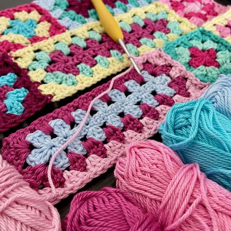 crochet is being used to create a granny's afghan with colored yarn