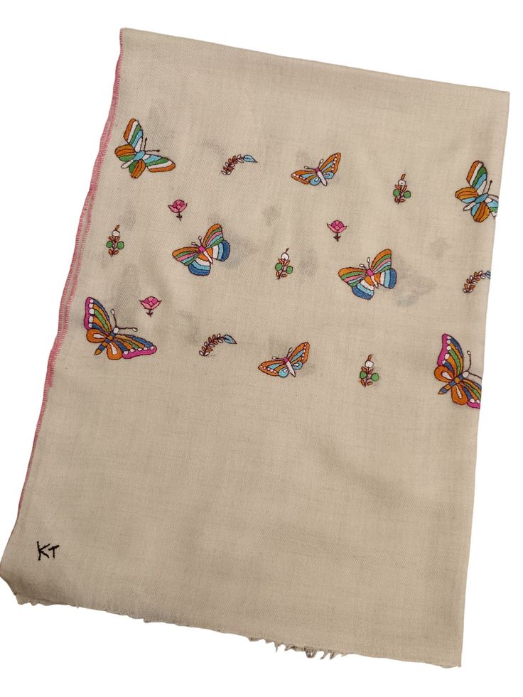 Hand embroidered needle art crafted on pure Pashmina stole .An elegant look of butterflies and other motifs on borders of the scarf by one of our finest artists . embroidery done with fine cotton thread. naturally super soft , light in weight and warm best for all seasons. Hand woven on Handloom Artisan :   Bilal Ahmad Bhat (weaver)/  Abdul Ahad Mir ( Embroider) color:       Natural un-dyed ivory base with multi color embroidery.  Wash:   Hand wash only / do not soak Shipping : From Kashmir-Indi White Embroidered Pashmina Scarf, Traditional Embroidered Cream Scarf, Traditional Cream Embroidered Scarf, Embroidered Cream Pashmina Shawl, Cream Embroidered Pashmina Scarf, Beige Embroidered Pashmina Scarf, Traditional Embroidered Shawl For Summer, Spring Traditional Pashmina Shawl, Spring Embroidered Beige Dupatta