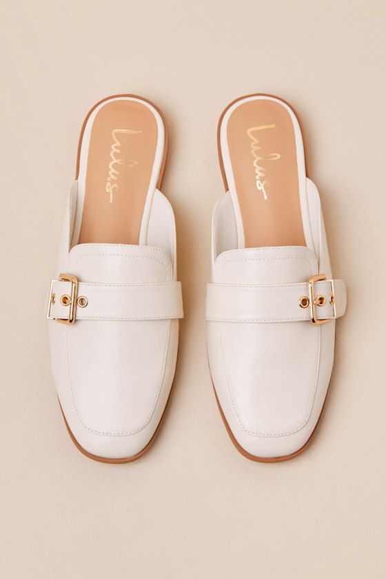 Upgrade your everyday flats with a chic new option like the Lulus Marquete Bone Buckle Mule Slides! These too-cute mules have a smooth, faux leather construction that shapes an almond toe upper and an adjustable strap with a gold buckle and matching grommets. Classic notched collar leads to a slide-on design for effortless styling. 0. 75" rubber heel. Cushioned insole. Rubber sole has nonskid markings. Man made materials. Imported. Lulus | Marquete Bone Buckle Mule Slides | Size 10. Spring Faux Leather Closed Toe Slip-ons, Spring Closed-toe Faux Leather Slip-ons, Chic Faux Leather Flats For Spring, Spring Mules For Everyday Use, Elegant Flat Mules For Spring, Flat Mules For Office, Everyday Closed Toe Mules For Spring, Spring Faux Leather Flat Mules, Beige Faux Leather Flats For Spring